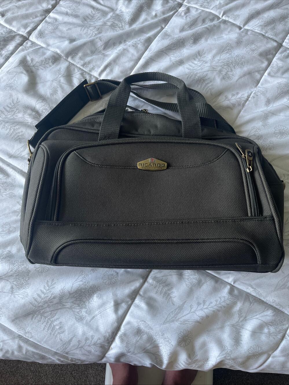 Ricardo gray carry-on travel bag with dual zip compartments and shoulder strap